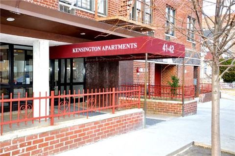 a apartments building with a red fence