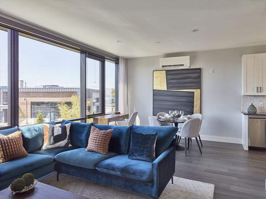 Residences spacious living room with floor to ceiling windows and hardwood flooring - Photo Gallery