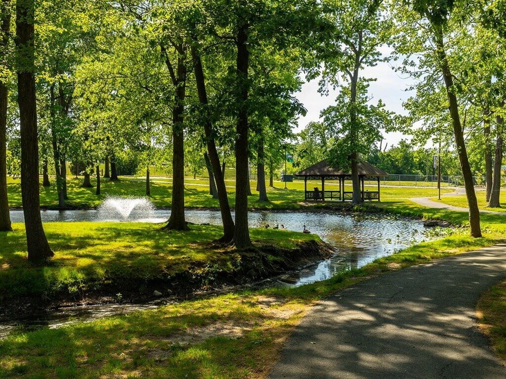 a park with a river and a gazebo