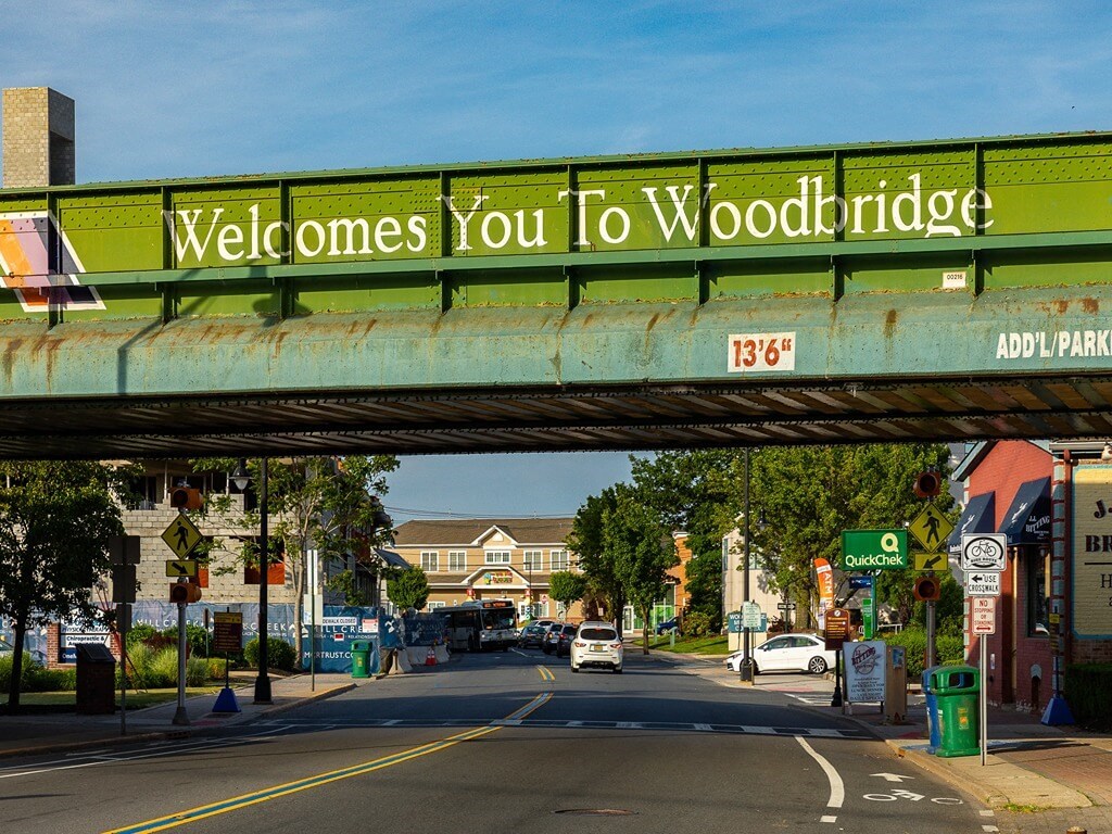 a sign that reads welcomes you to woodridge on a bridge over a city street