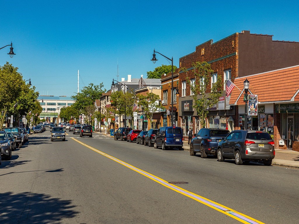 a city street with cars parked on the side of the road