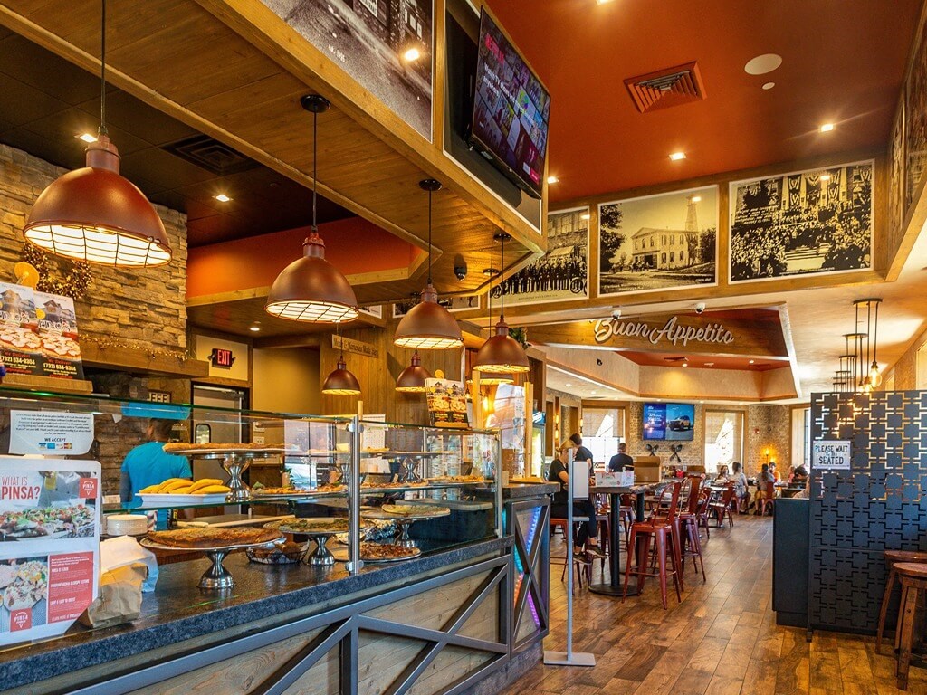 the interior of a restaurant with people eating at the counter