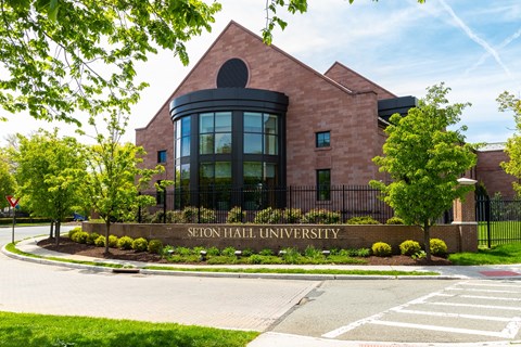 A brick building with a sign that says "SEFTON HALL UNIVERSITY" in front of it.
