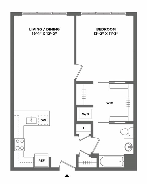A floor plan of a small apartment with a living/dining area, bedroom, and a WC.