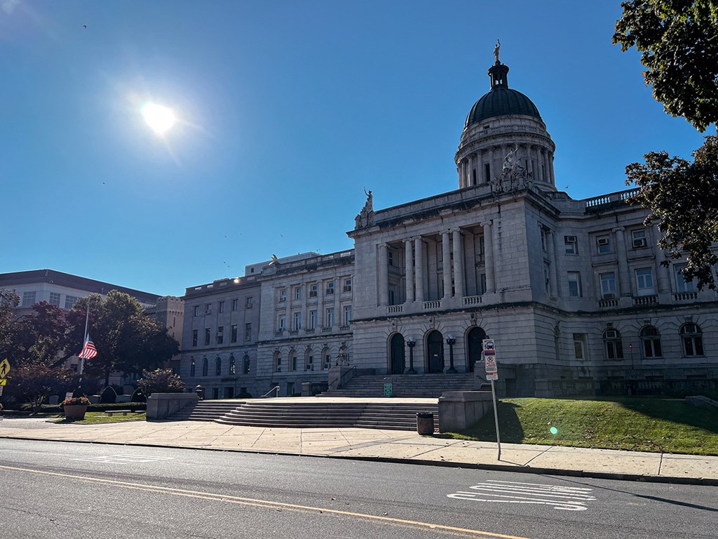 a large building on a sunny day with the sun in the sky