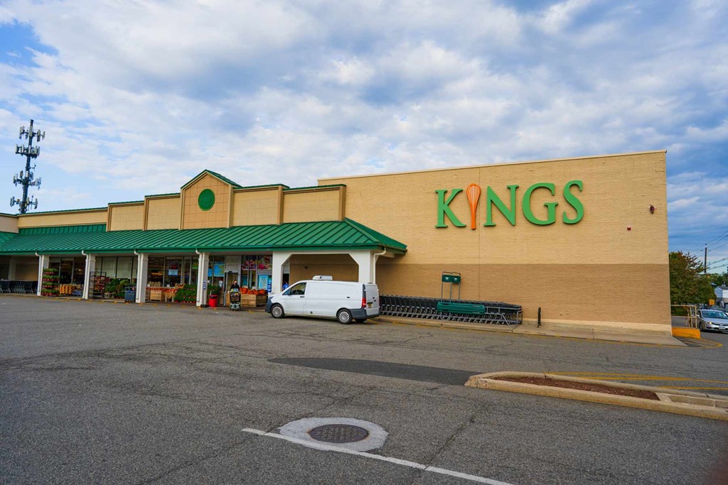 A Kings store with a white van in front.