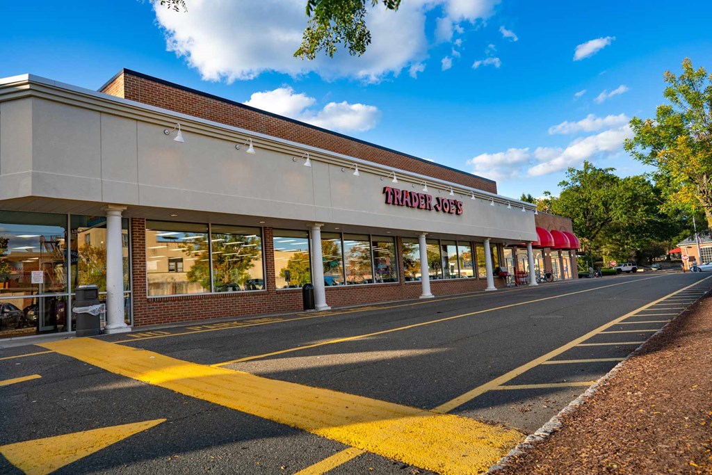 A Thai Joe's restaurant with a red awning and yellow parking lines in front.