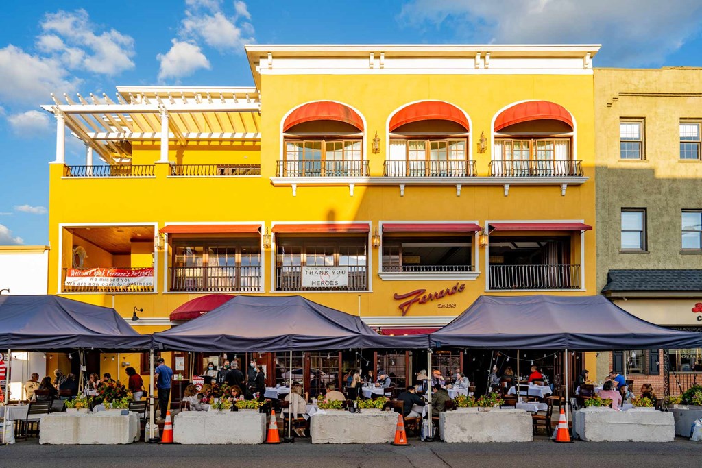 A yellow building with red awnings and a sign that says "Fresco".