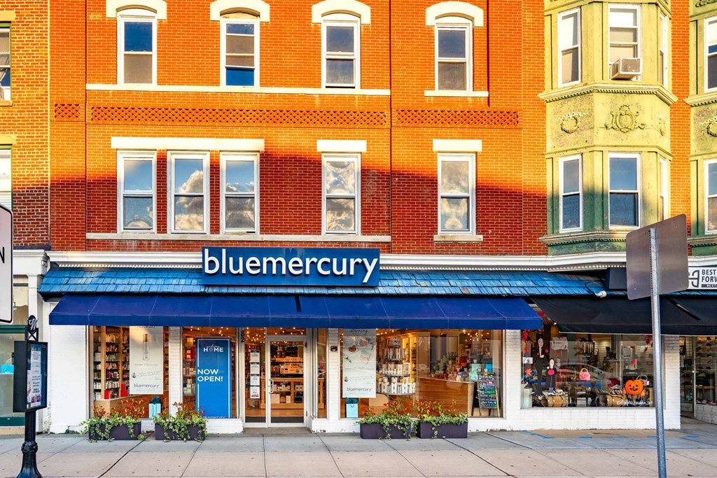 A storefront with a blue awning and the name "bluemercury" on it.