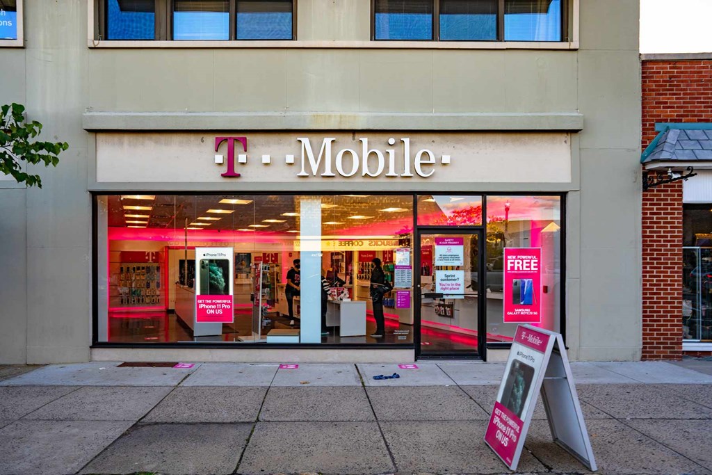 A T-Mobile storefront with a sign offering free phones.