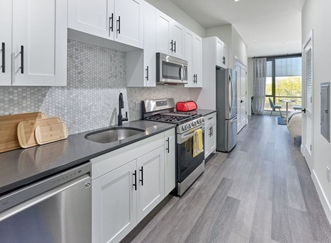 a kitchen with stainless steel appliances and white cabinets