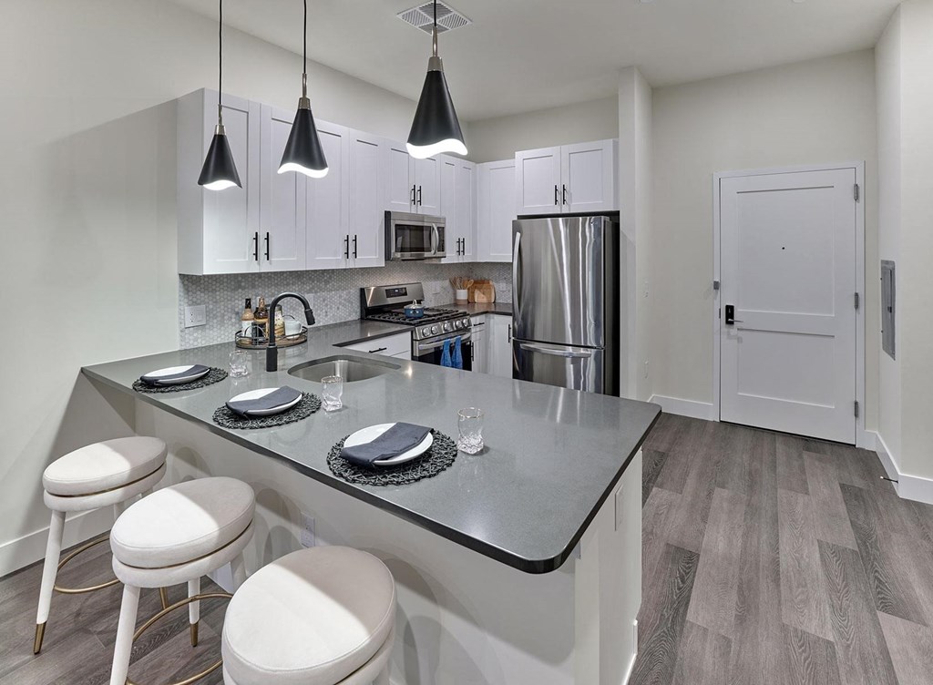 large kitchen, stainless steel appliances, custom cabinetry