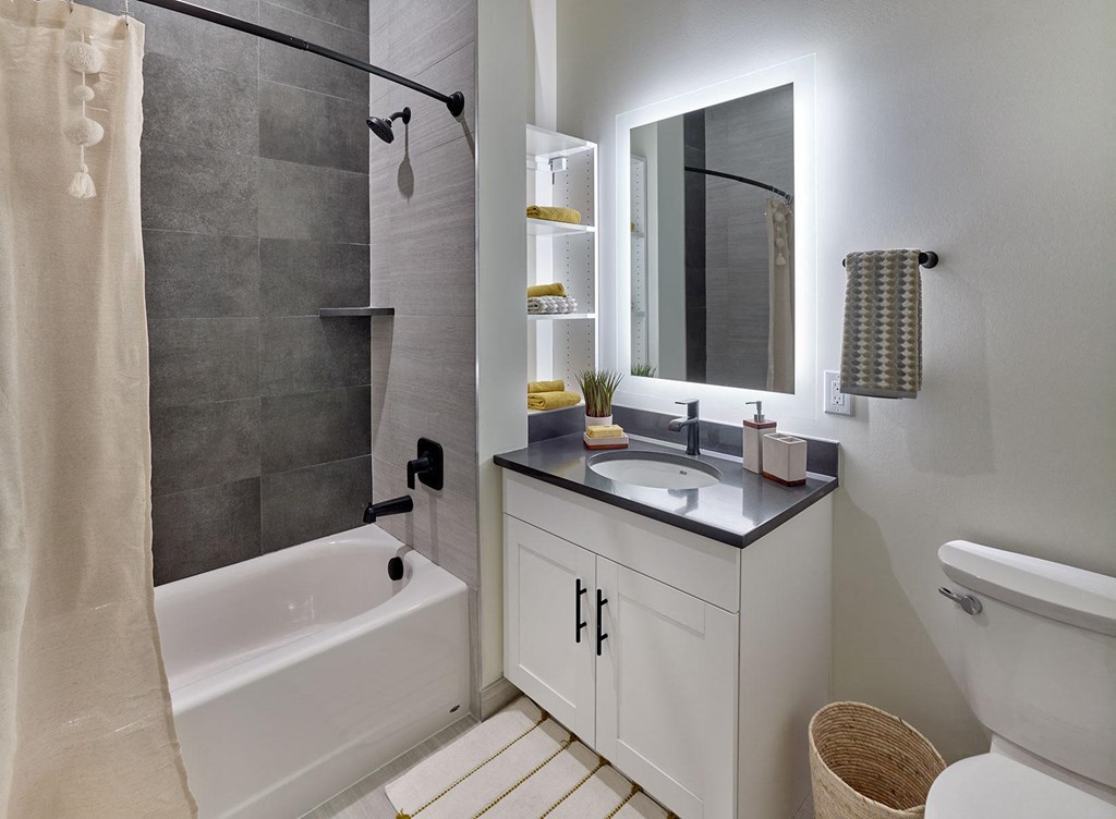 backlit vanity, marble tile shower