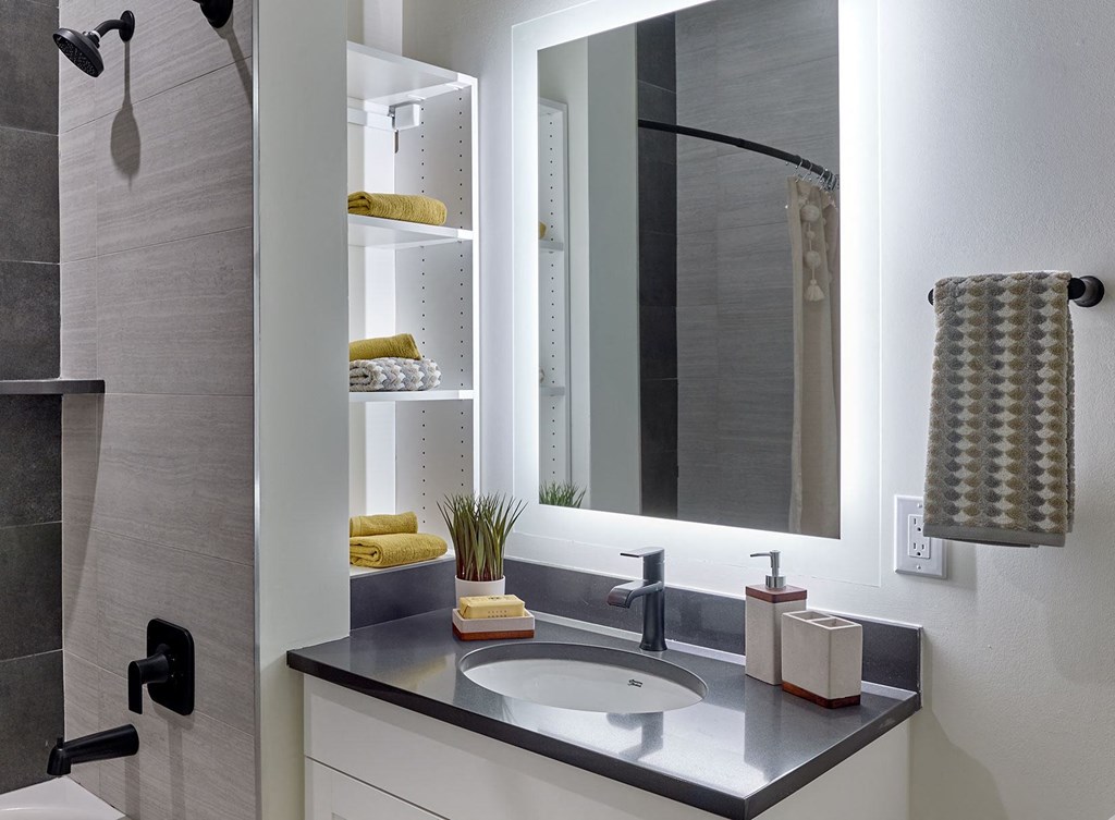 backlit vanity, marble tile shower,