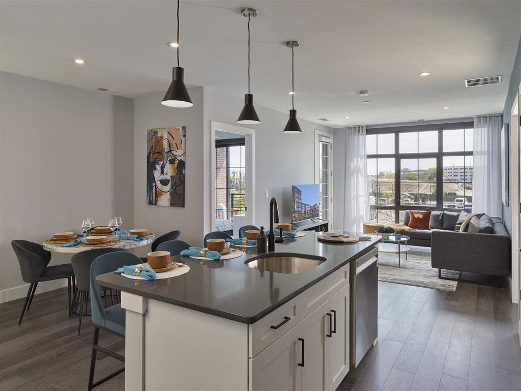 A modern kitchen with a dining table set for four.