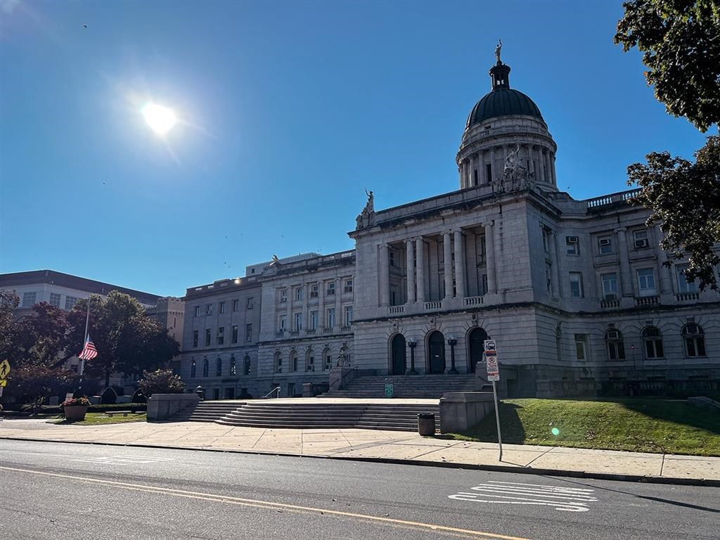 A large, stately building with a dome and columns is the main focus of the image.