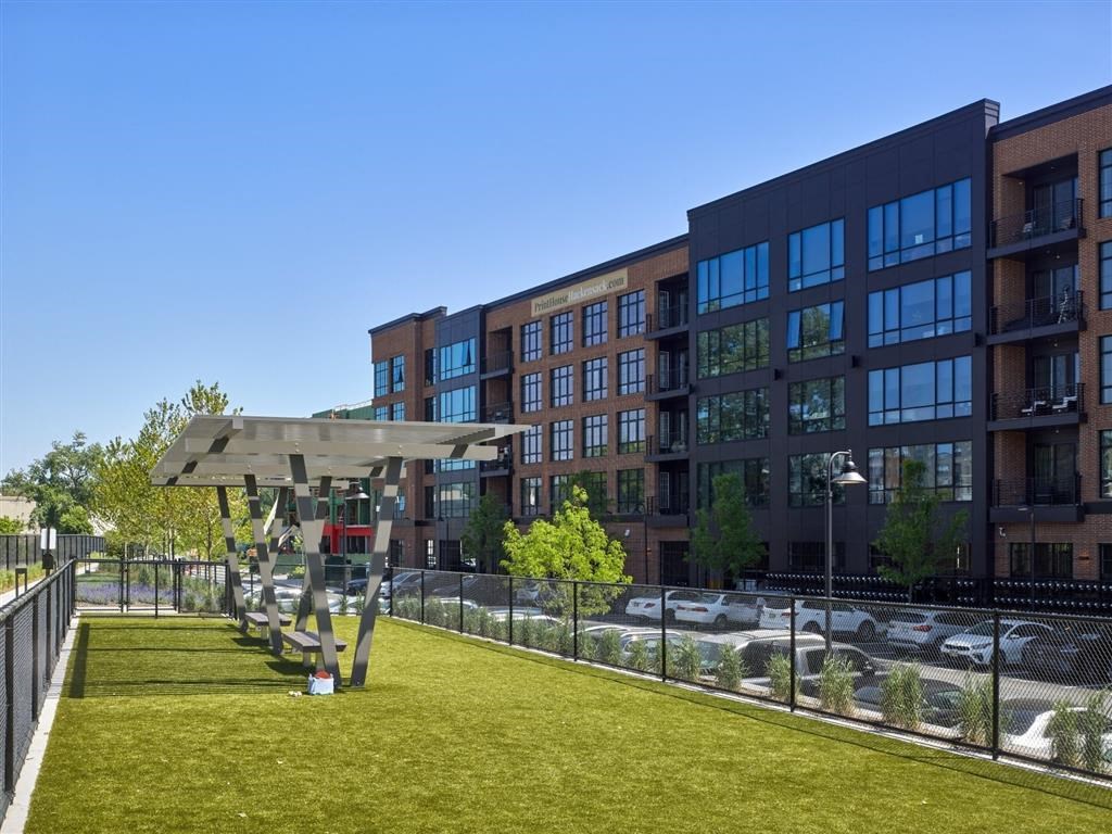 A modern building with a parking lot in front.