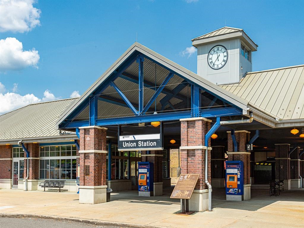 a train station with a clock on the front of it
