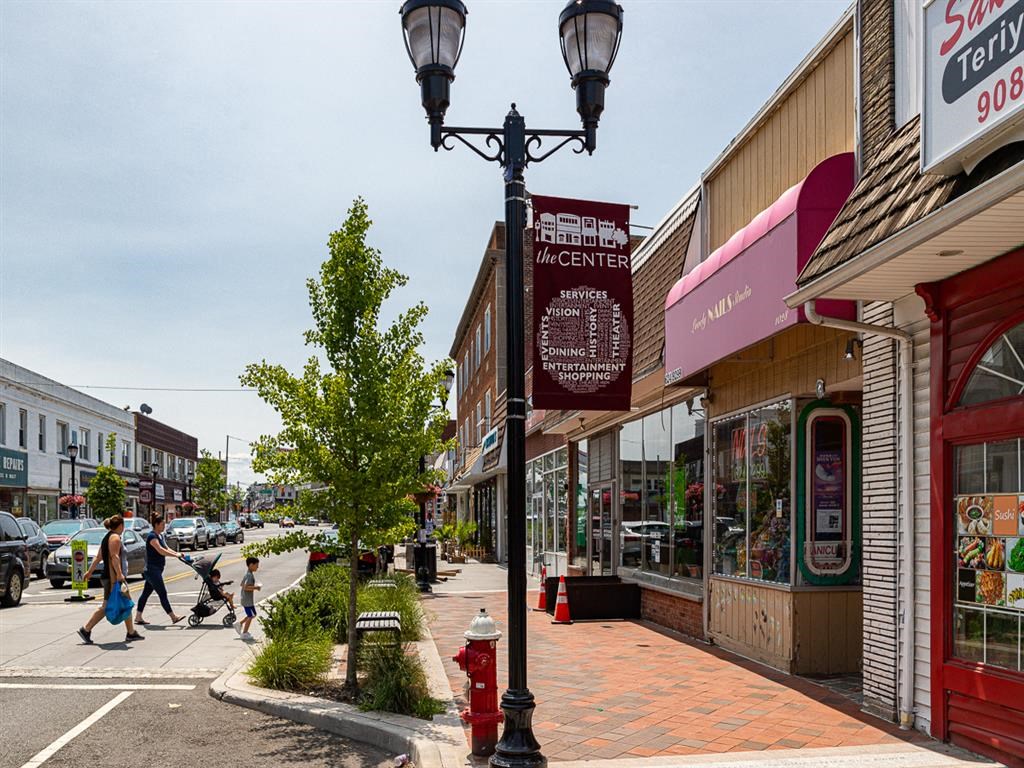 a city street with people walking down it