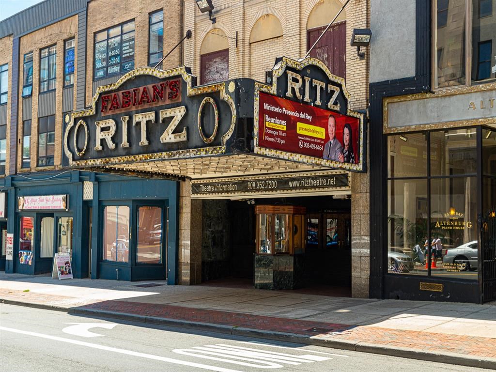 a theater marquee on the side of a building on a city street