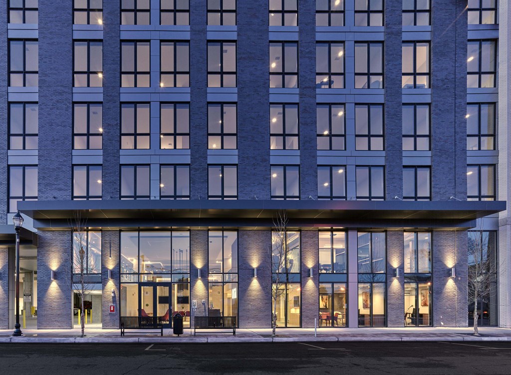 Neighborhood Exterior view of Ora luxury apartments with vibrant architecture and illuminated windows in Hackensack, NJ