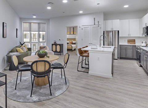 A modern kitchen with a dining table set for four.