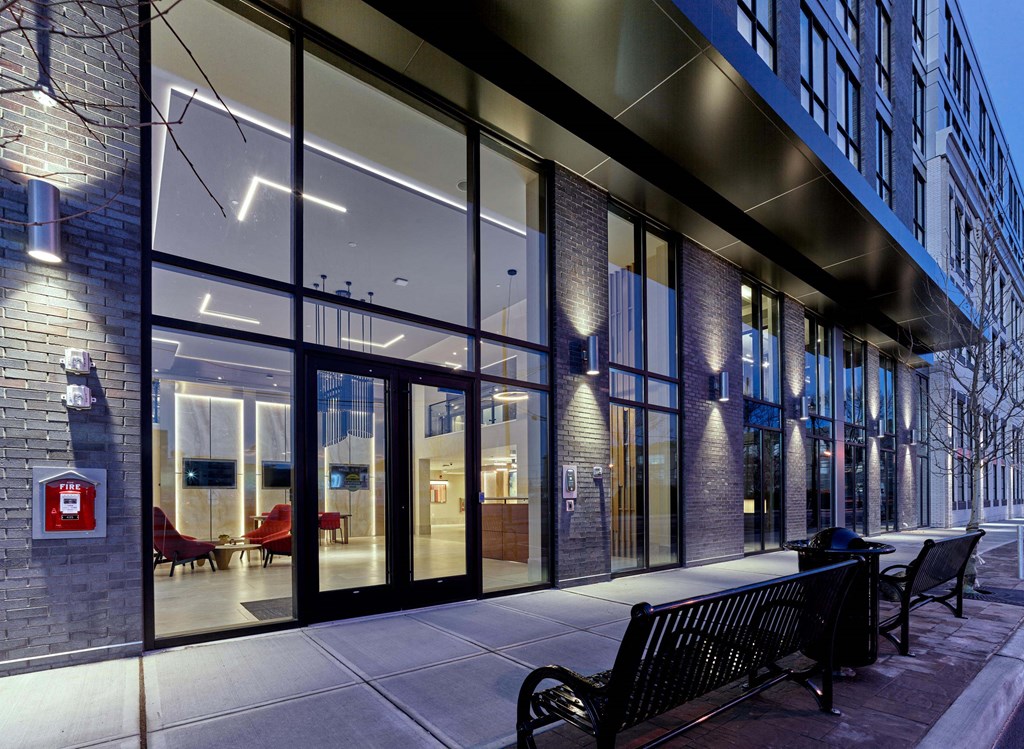 Exterior night view of Ora luxury apartments with illuminated windows in Hackensack, NJ