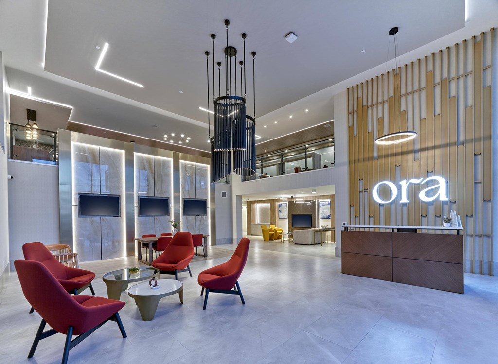 Stylish lobby with seating area and high ceilings at Ora luxury apartments in Hackensack, NJ