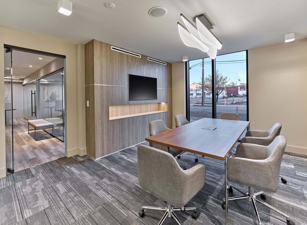 Resident lounge with cozy seating, flat-screen TV, and modern design at Ora in Hackensack, NJ