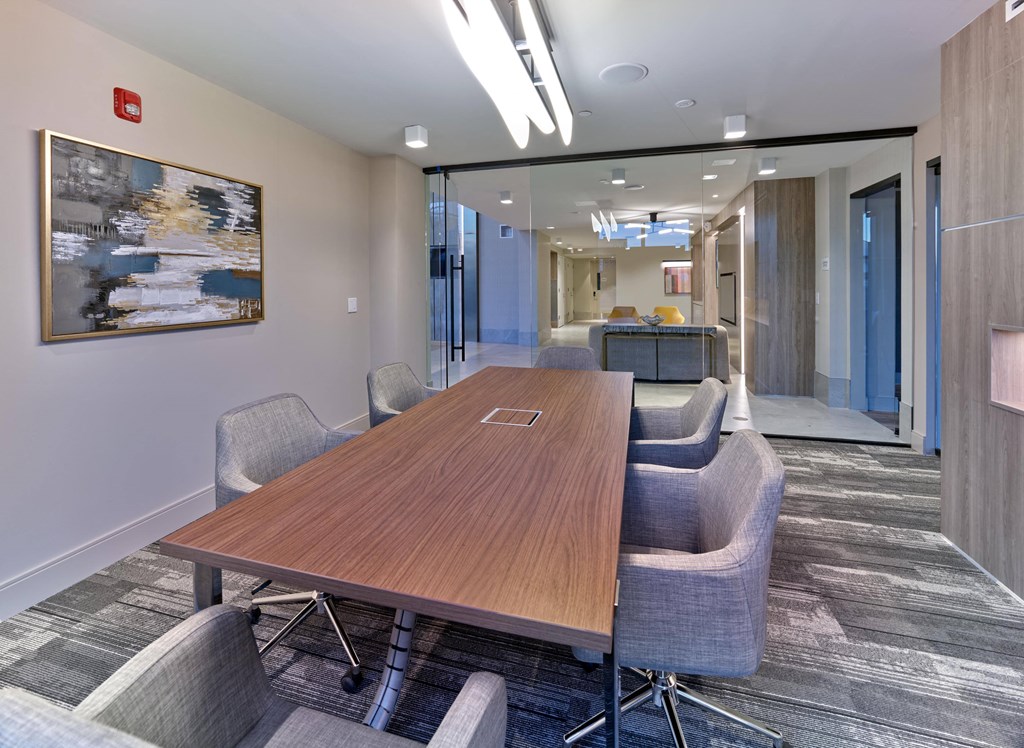 Private meeting room with large conference table and modern lighting at Ora in Hackensack, NJ