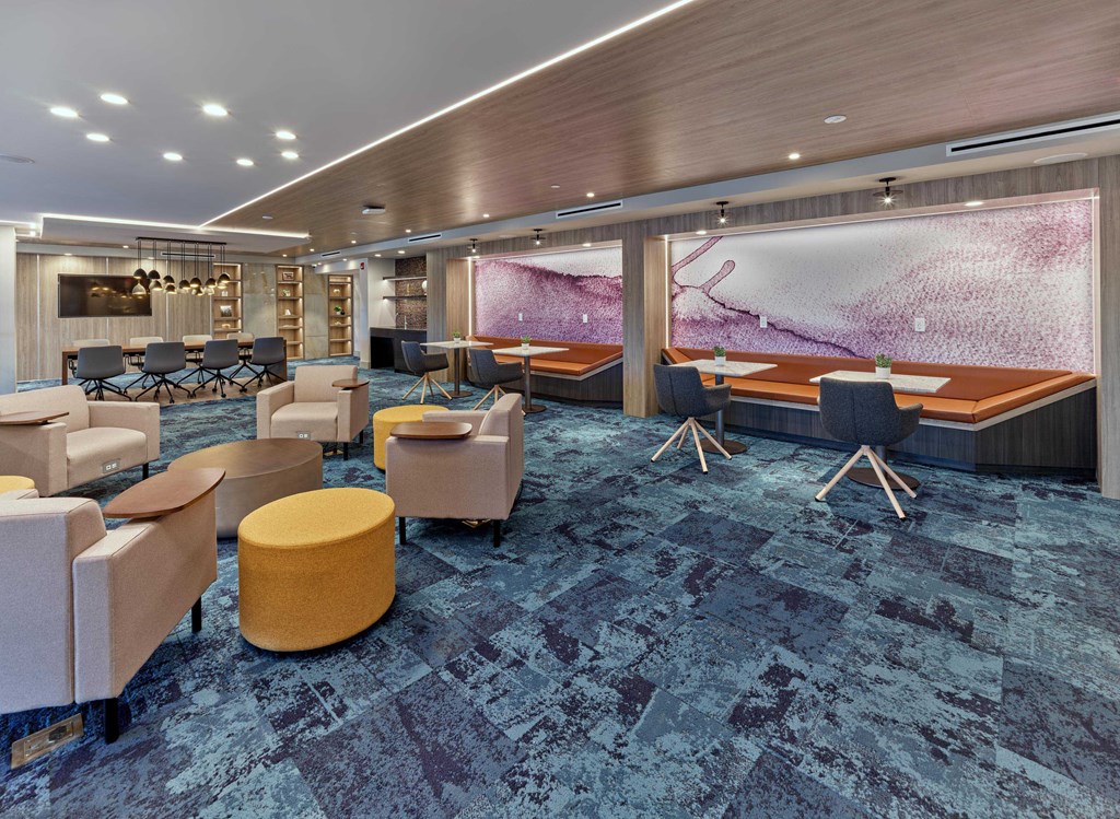 Elegant resident lounge with modern seating and vibrant decor at Ora luxury apartments in Hackensack, NJ