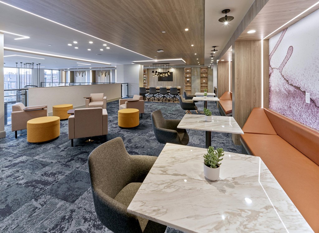 Elegant common area with large tables and modern lighting at Ora luxury apartments in Hackensack, NJ
