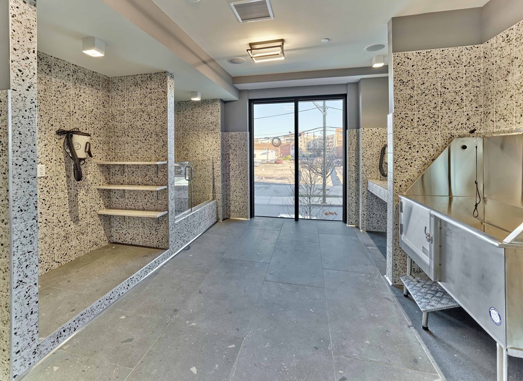 Dog spa area with modern design, tiled walls, and grooming facilities at Ora luxury apartments in Hackensack, NJ