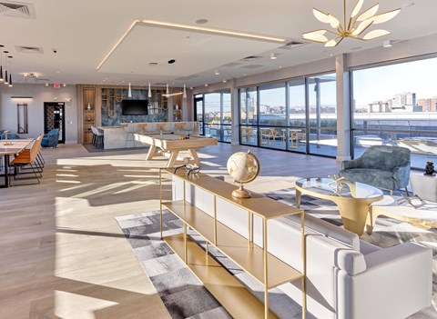 A modern living room with a white sofa and a gold coffee table.