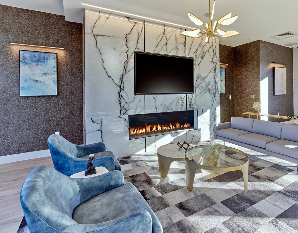 Cozy seating area with a wall-mounted TV and elegant decor at Ora in Hackensack, NJ