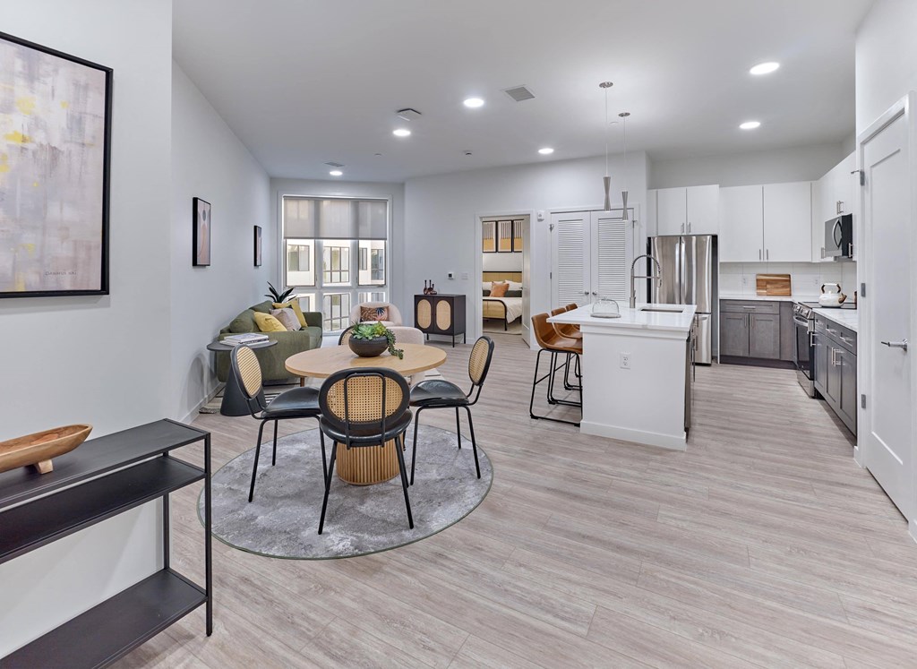 spacious, open living and dining area with modern decor and natural lighting at Ora luxury apartments in Hackensack, NJ