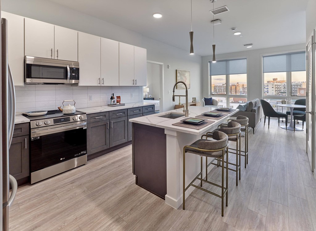 Open-concept kitchen with functional island and sophisticated cabinetry at Ora in Hackensack, NJ