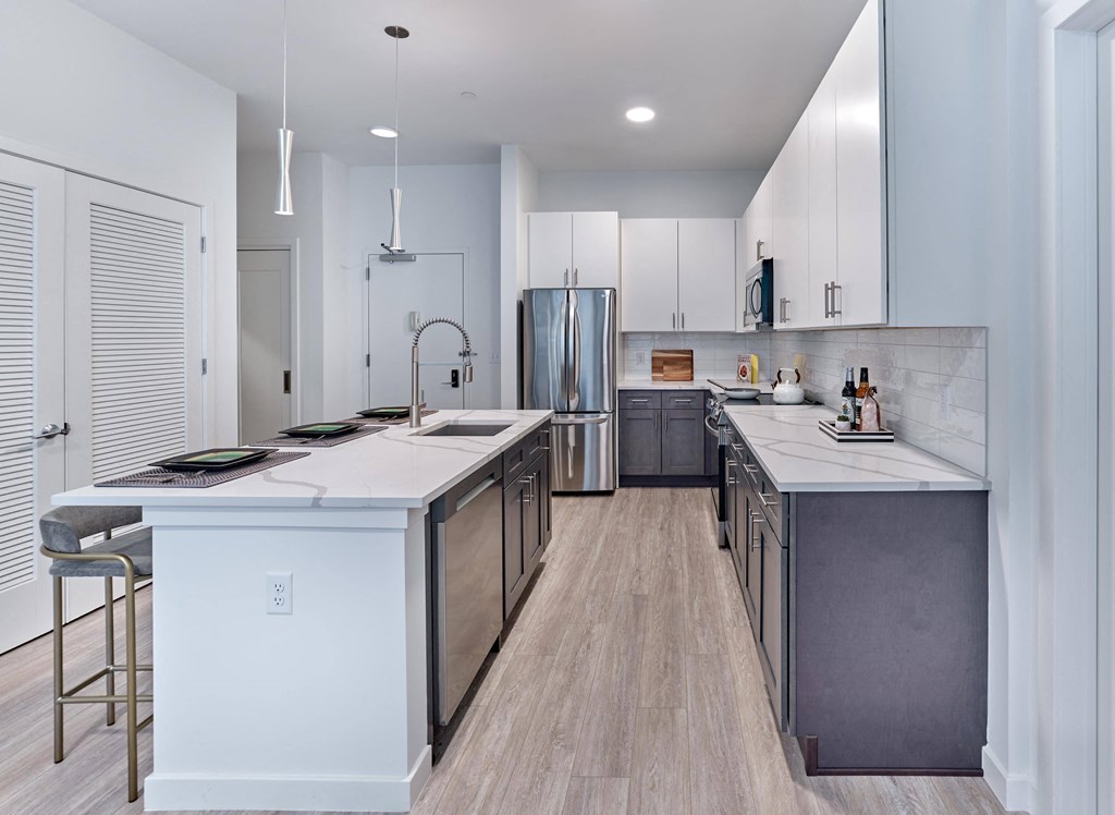 Modern kitchen with stainless steel appliances and spacious countertops at Ora in Hackensack, NJ
