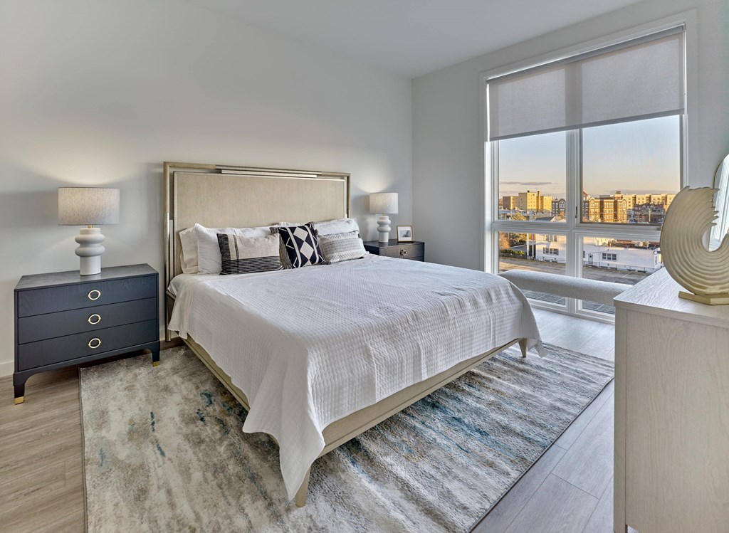 Spacious bedroom with large windows and sleek modern design at Ora in Hackensack, NJ