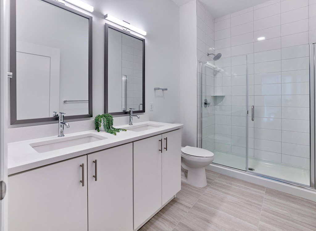 Modern bathroom with jack and jill vanity, bright lighting, and sleek cabinetry at Ora luxury apartments in Hackensack, NJ