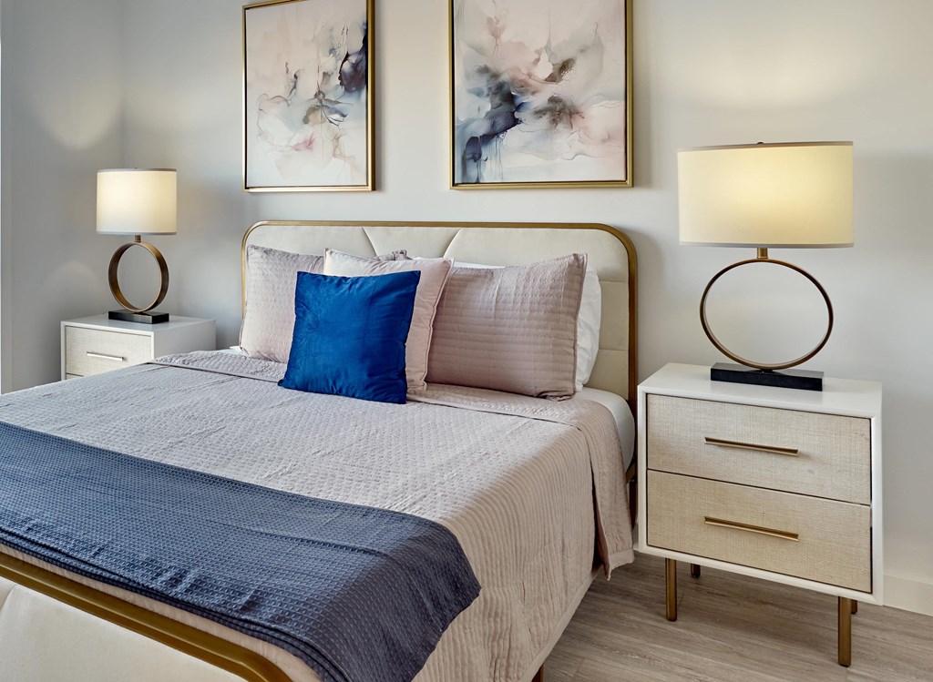 Cozy bedroom with stylish bedding and modern furnishings at Ora in Hackensack, NJ