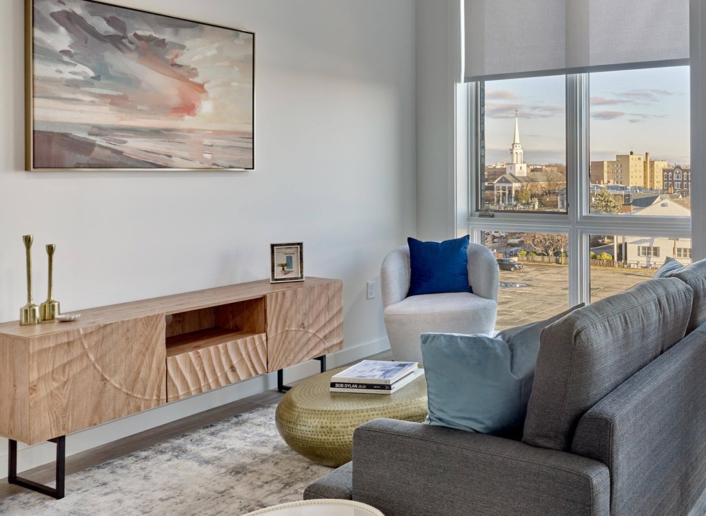 Living room with large windows, contemporary decor, and natural light at Ora luxury apartments in Hackensack, NJ