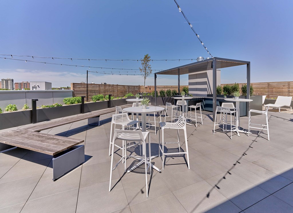 A patio with a table and chairs under a pergola.