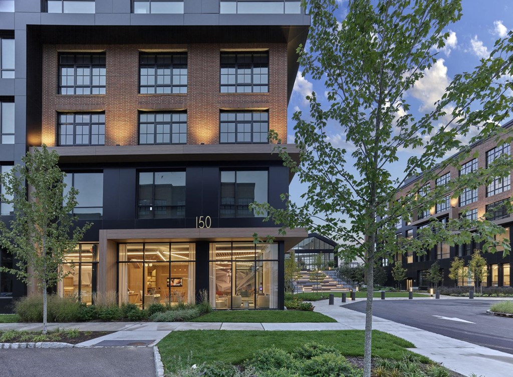 Beautiful exterior of Print House Apartments illuminated at dusk in Hackensack, NJ