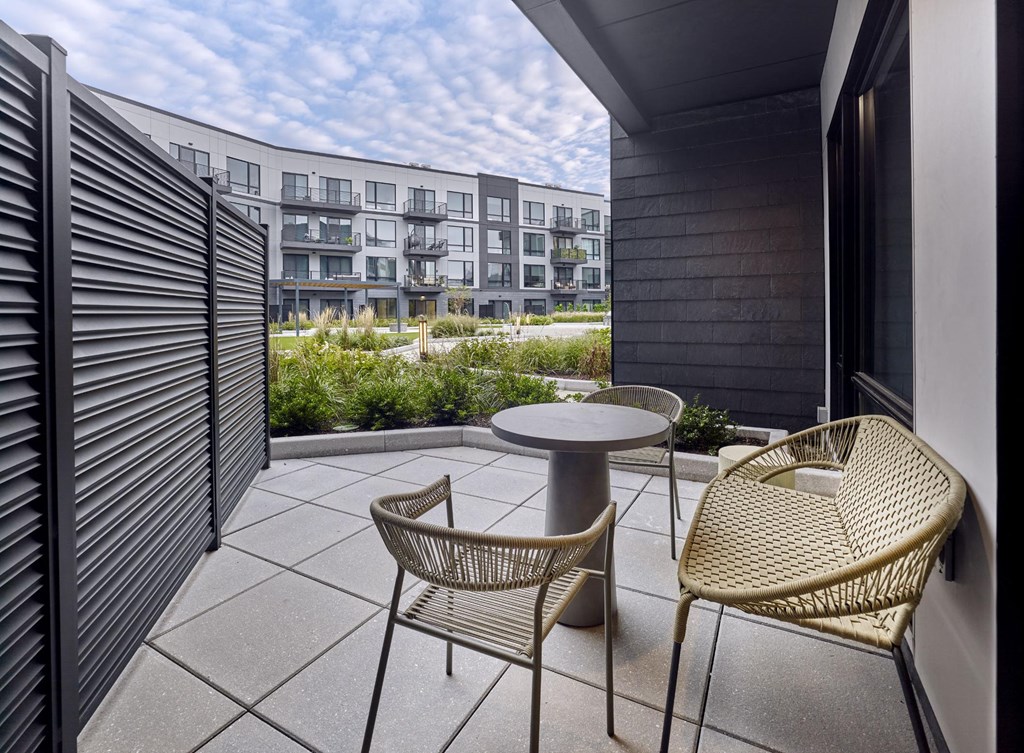 Private outdoor patio space with modern seating at Print House Apartments, Hackensack, NJ