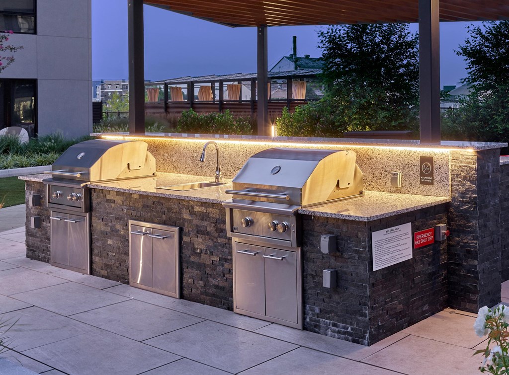 A barbecue area with a grill and sink.