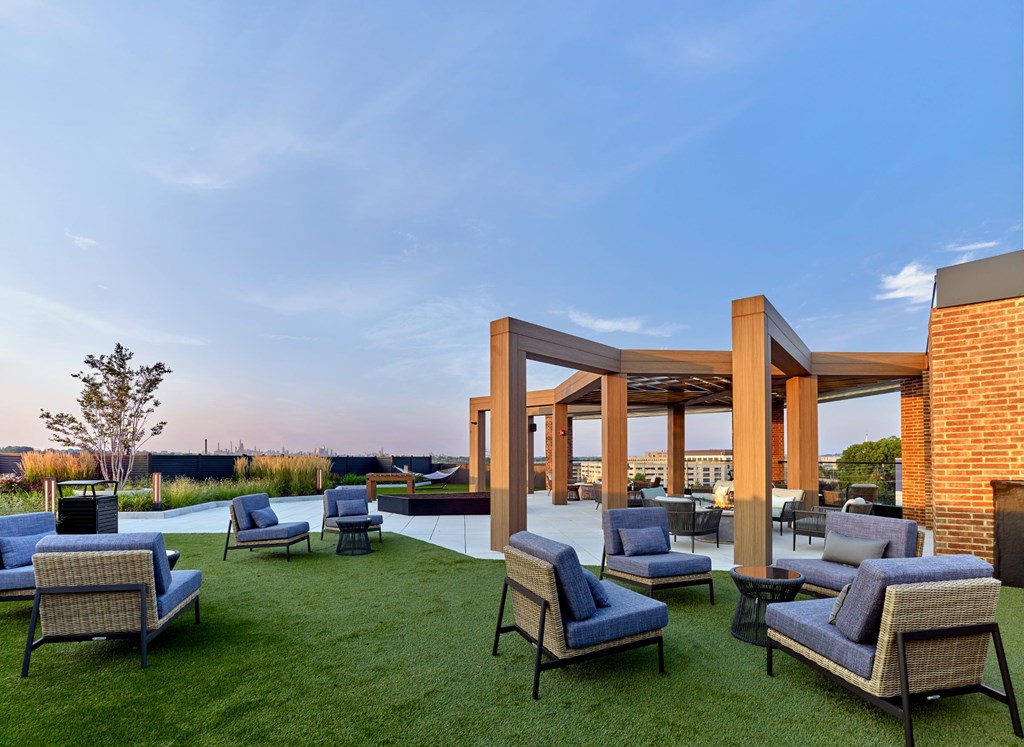 A patio with blue chairs and a white table.