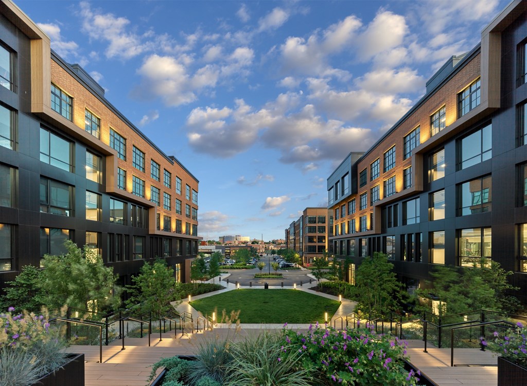A modern building complex with a garden in the middle.