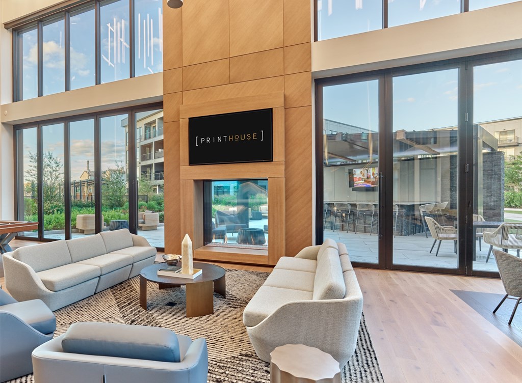 A living room with a large window and a sign that says