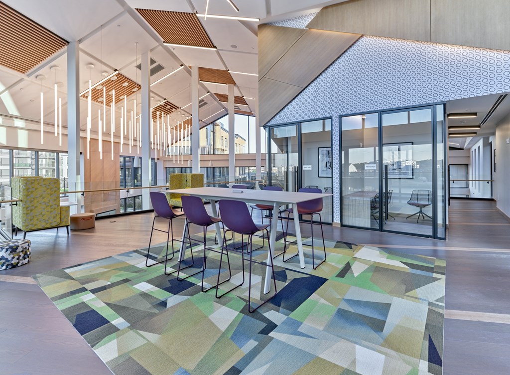 A modern dining room with a table set for four.
